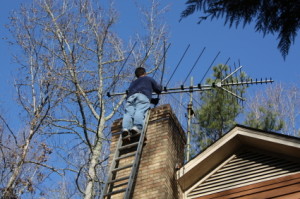 Chimney Sweep on Ladder - Clean Sweeps of Michigan