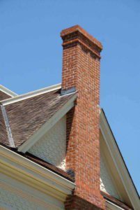 masonry chimney on side of home